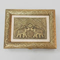 Top view of dry fruit box lid featuring two facing elephants, decorative arches and an ornate gold-tone floral border