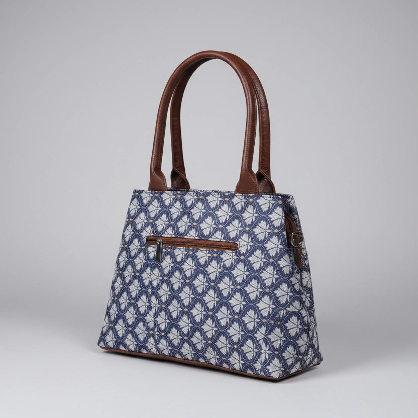 Backside view of premium cotton handbag showing the extra zip pocket and floral fabric detail.