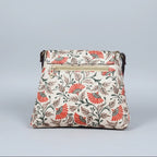 The reverse side of the fabric sling bag highlighting the third zippered pocket for quick-access items.
