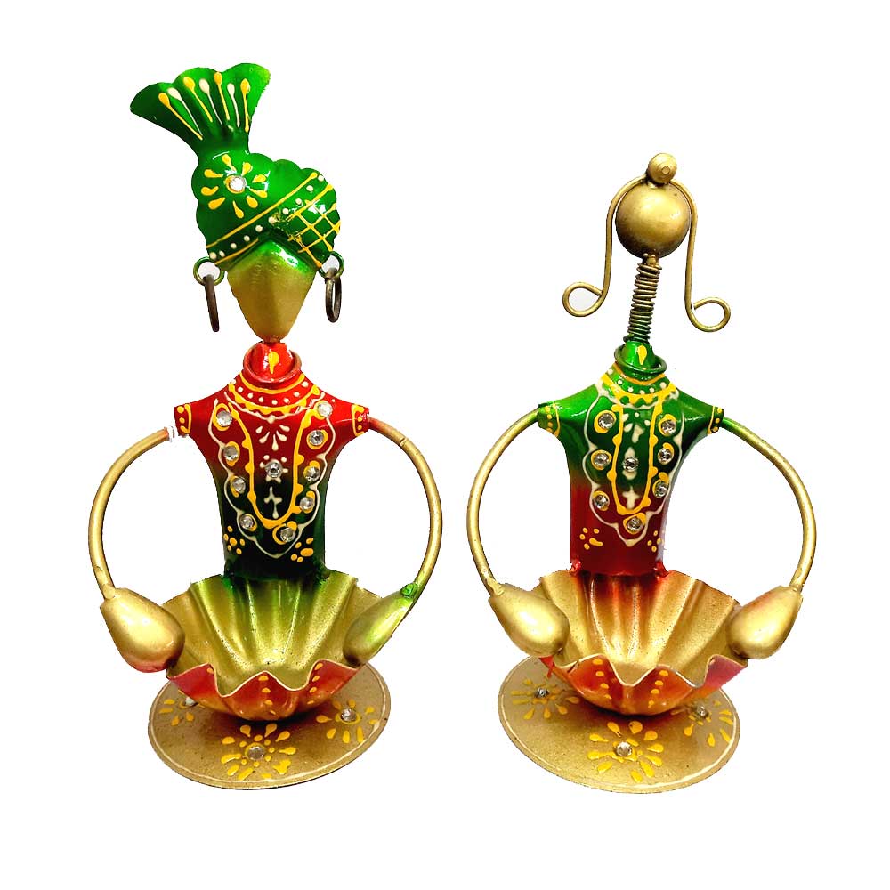 A statue of a man and a woman holding a metal candle holder.