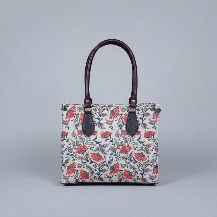 Detailed texture of the premium floral print on the ethnic fabric handbag.
