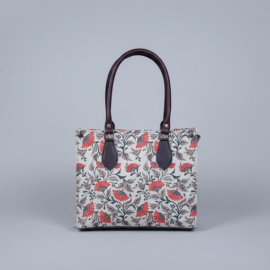 Detailed texture of the premium floral print on the ethnic fabric handbag.