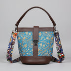 Front view of a 9x9 inch square sling bag featuring a vibrant floral print fabric and brown PU leather accents.