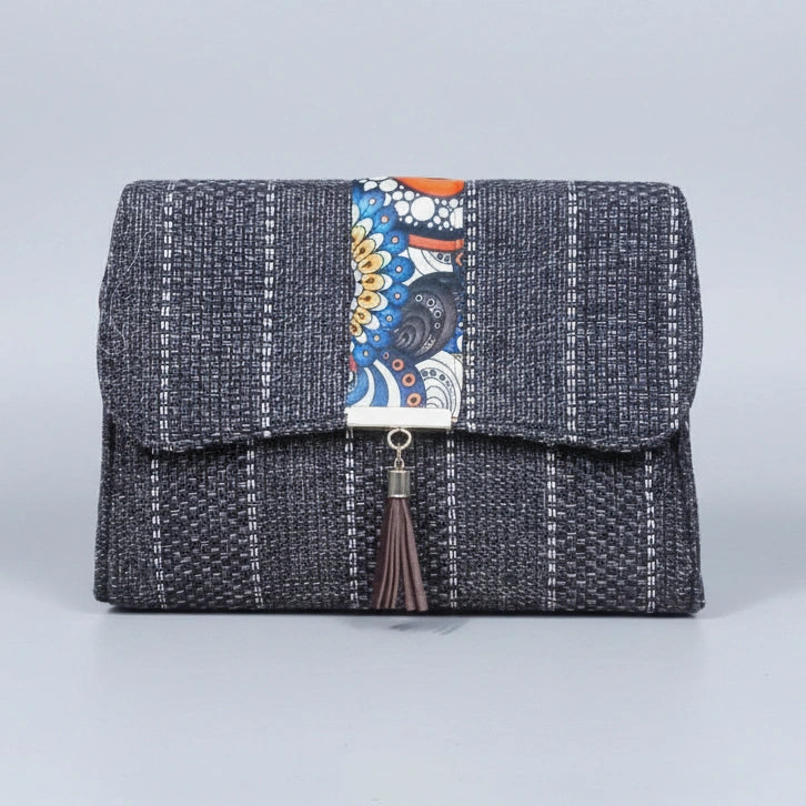 Front view of the floral finesse flap sling bag with textured fabric and leather tassel