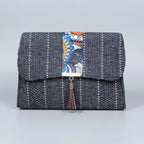 Front view of the floral finesse flap sling bag with textured fabric and leather tassel