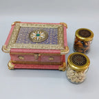 Floral gift box displayed beside two decorative jars containing almonds and cashews