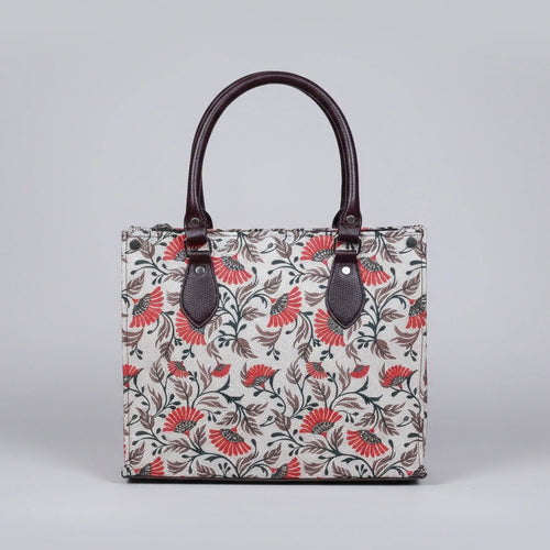 Front view of a premium floral print fabric handbag with PU leather handles.