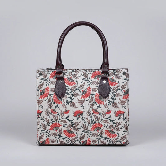Front view of a premium floral print fabric handbag with PU leather handles.