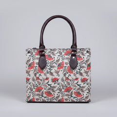 Front view of a premium floral print fabric handbag with PU leather handles.
