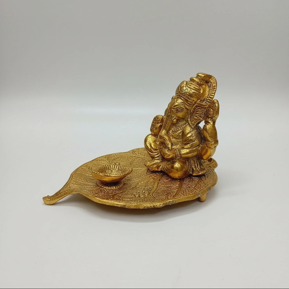 Handcrafted metal Ganesh on Peepal leaf, a perfect traditional gift for Grah Pravesh, weddings, and birthdays.