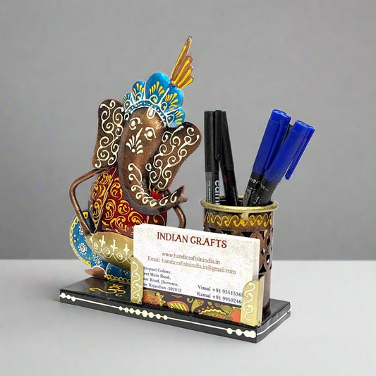 A Ganesha-themed metal pen stand and card holder with beautiful hand painting.