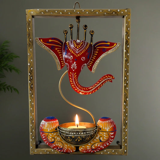 Hand-painted metal wall frame featuring Lord Ganesha with a built-in tealight candle stand.