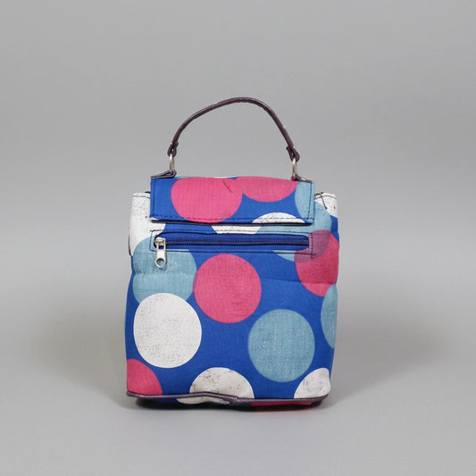 Geometric printed sling bag featuring both a side sling strap and a top handle