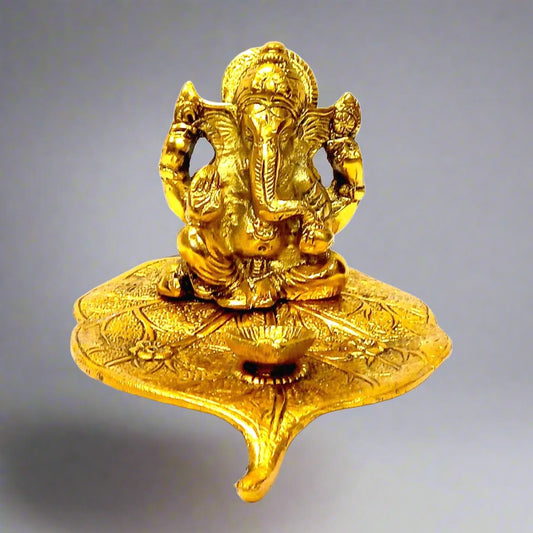 A golden Ganesha statue that doubles as a diya holder, a perfect showpiece for any auspicious occasion.