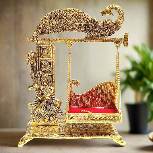 Golden metal Laddu Gopal Jhula swing with peacock design for home temple.