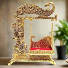 Golden metal Laddu Gopal Jhula swing with peacock design for home temple.
