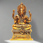 A golden metal Ganesh wall decor piece with an intricate traditional design.
