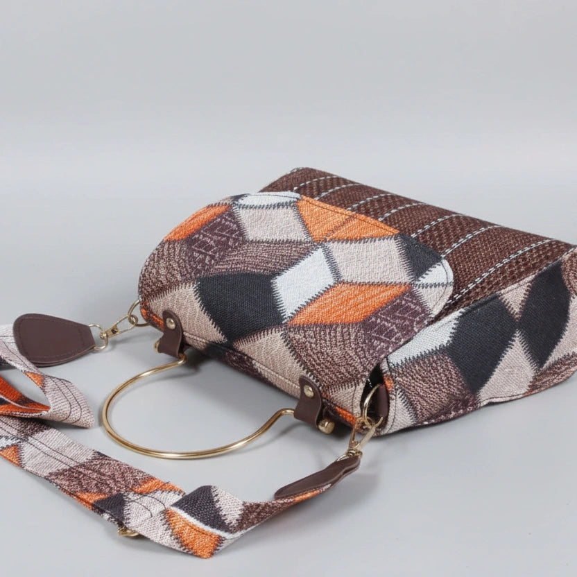 Elegant golden metal handle detail on a luxury textured sling bag