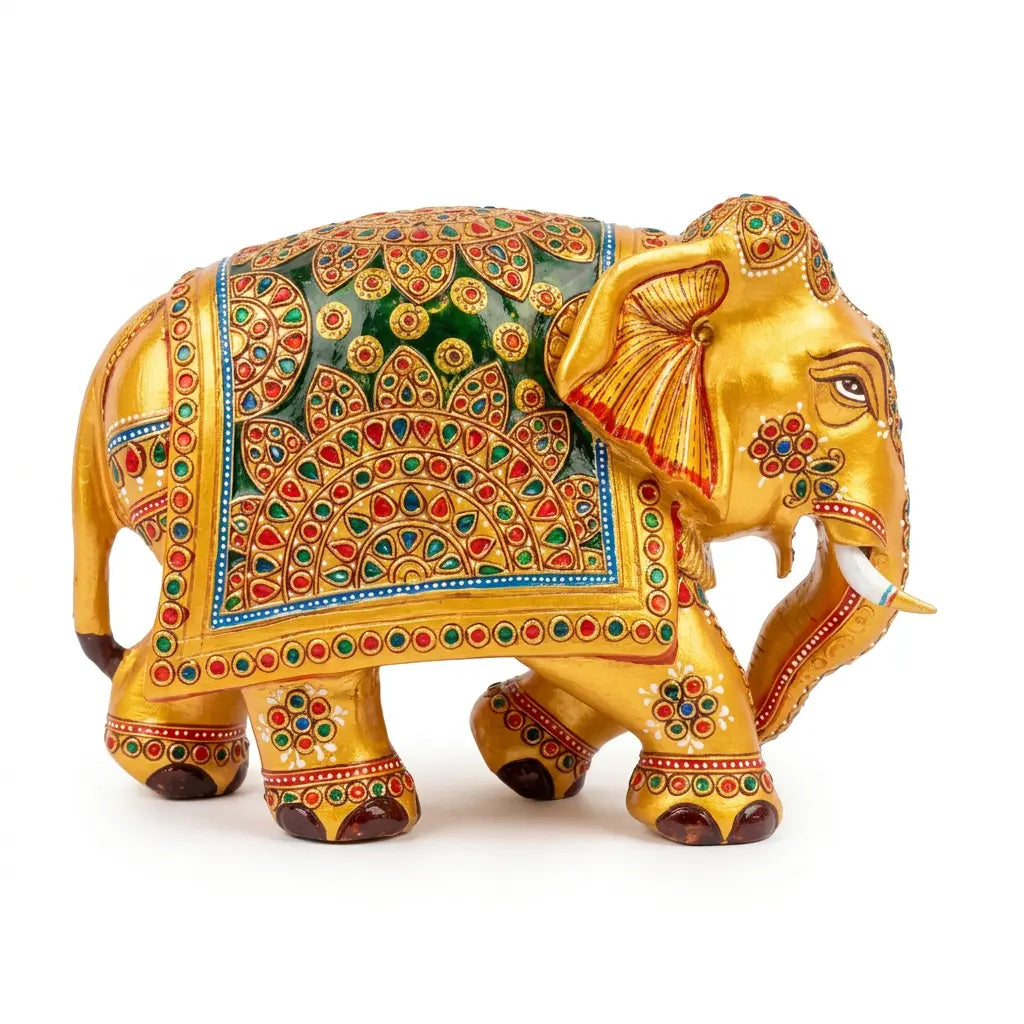 Right-facing hand-painted wooden elephant with golden body and green, red and blue ornamental detailing
