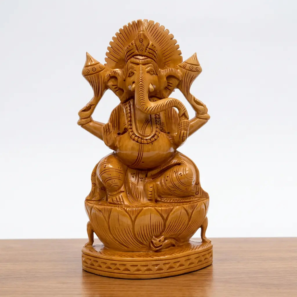 Front view of hand-carved wooden Ganesh seated on a lotus pedestal, with a detailed crown and raised blessing hand