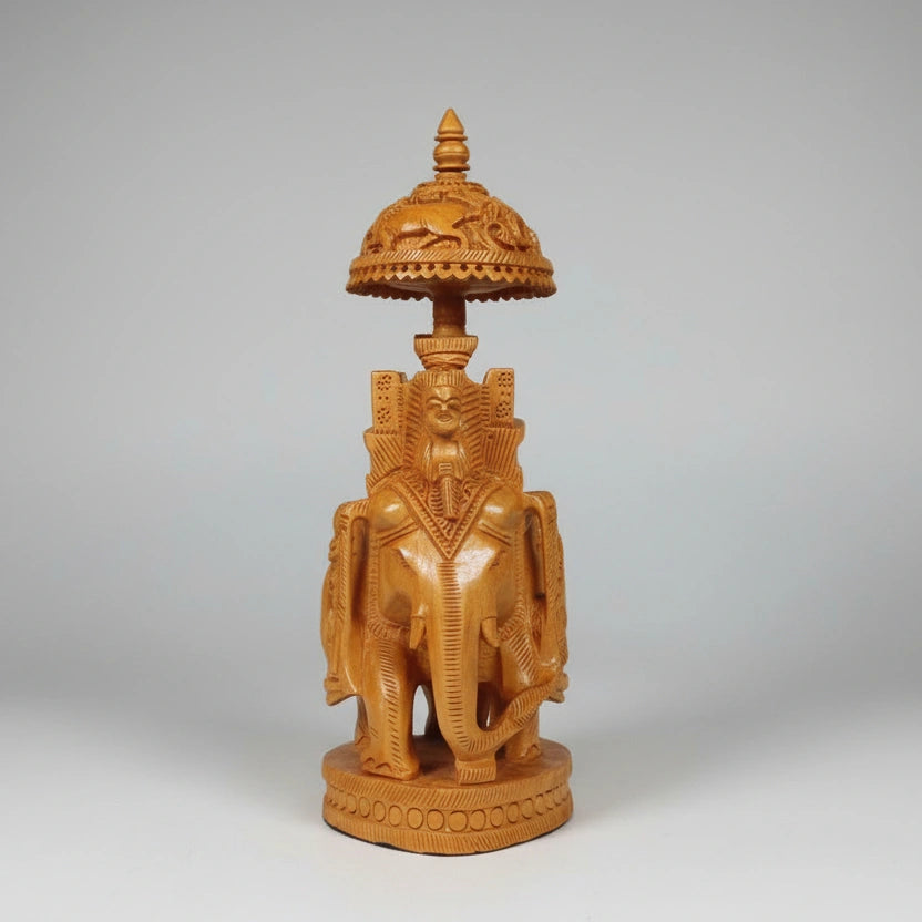 Artisanal wood carving of a traditional Mahavat riding a royal Ambabari elephant with deep-relief textures.