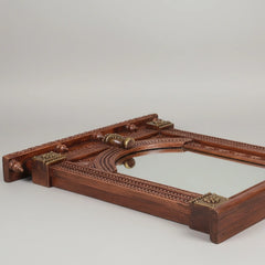 Close-up of the intricate hand-carved patterns on a copper-finished wooden Jharokha.