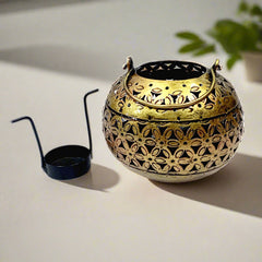 Hand-crafted metal candle stand with golden oxidized finish and mesh design, enhancing any home ambiance.