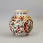 Detailed view of a premium round marble pot with high-quality embossed painting of a peacock surrounded by traditional floral vines.