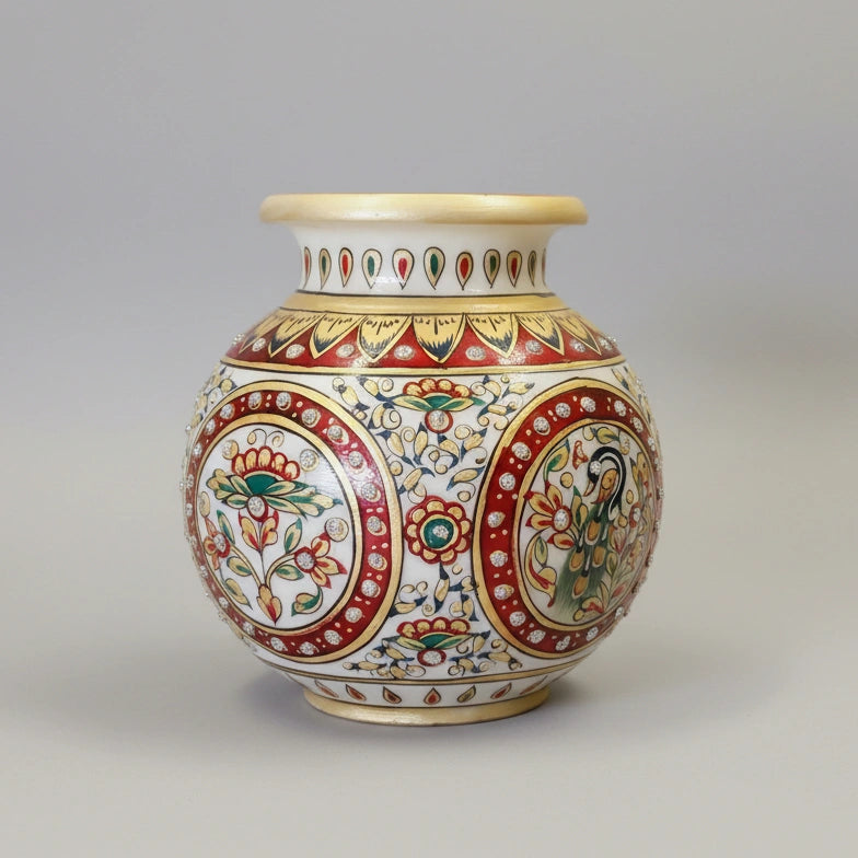 Detailed view of a premium round marble pot with high-quality embossed painting of a peacock surrounded by traditional floral vines.