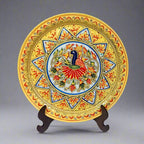 Round marble plate featuring vibrant hand-painted peacock and embossed floral patterns, showcasing intricate artistry and elegant colors.