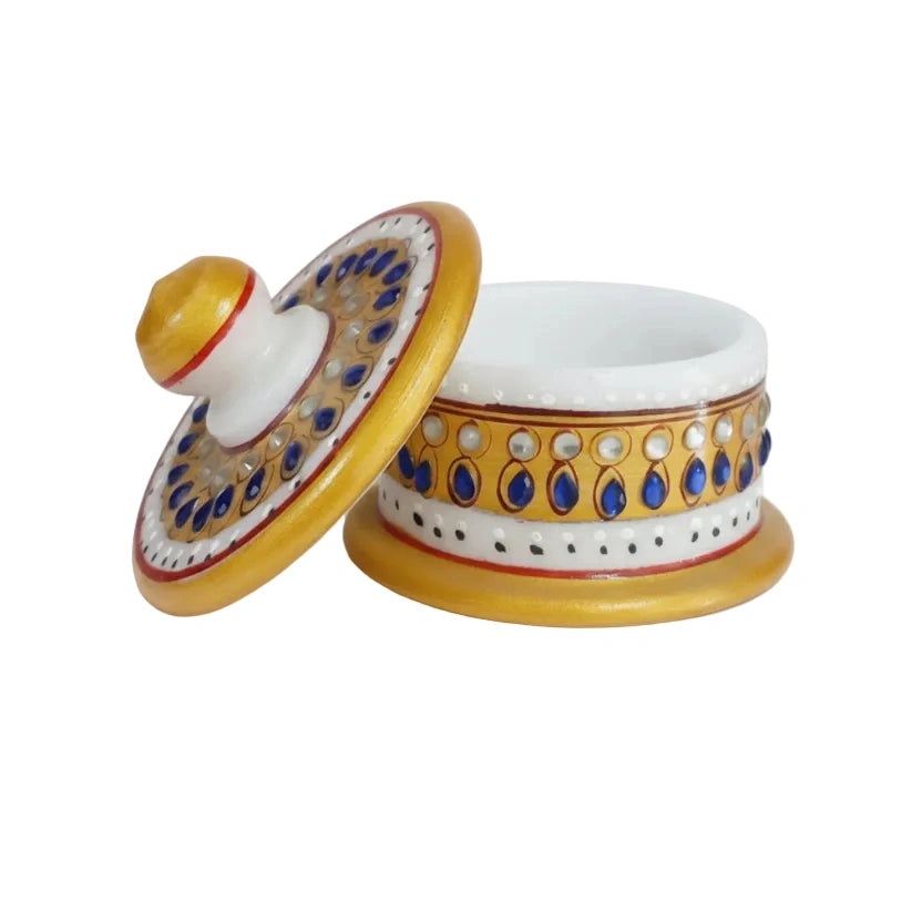 Hand-painted marble Sindoor box with traditional Indian floral patterns.