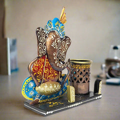 A hand-painted metal Ganesha desk accessory, a sturdy piece that adds beauty to any table.