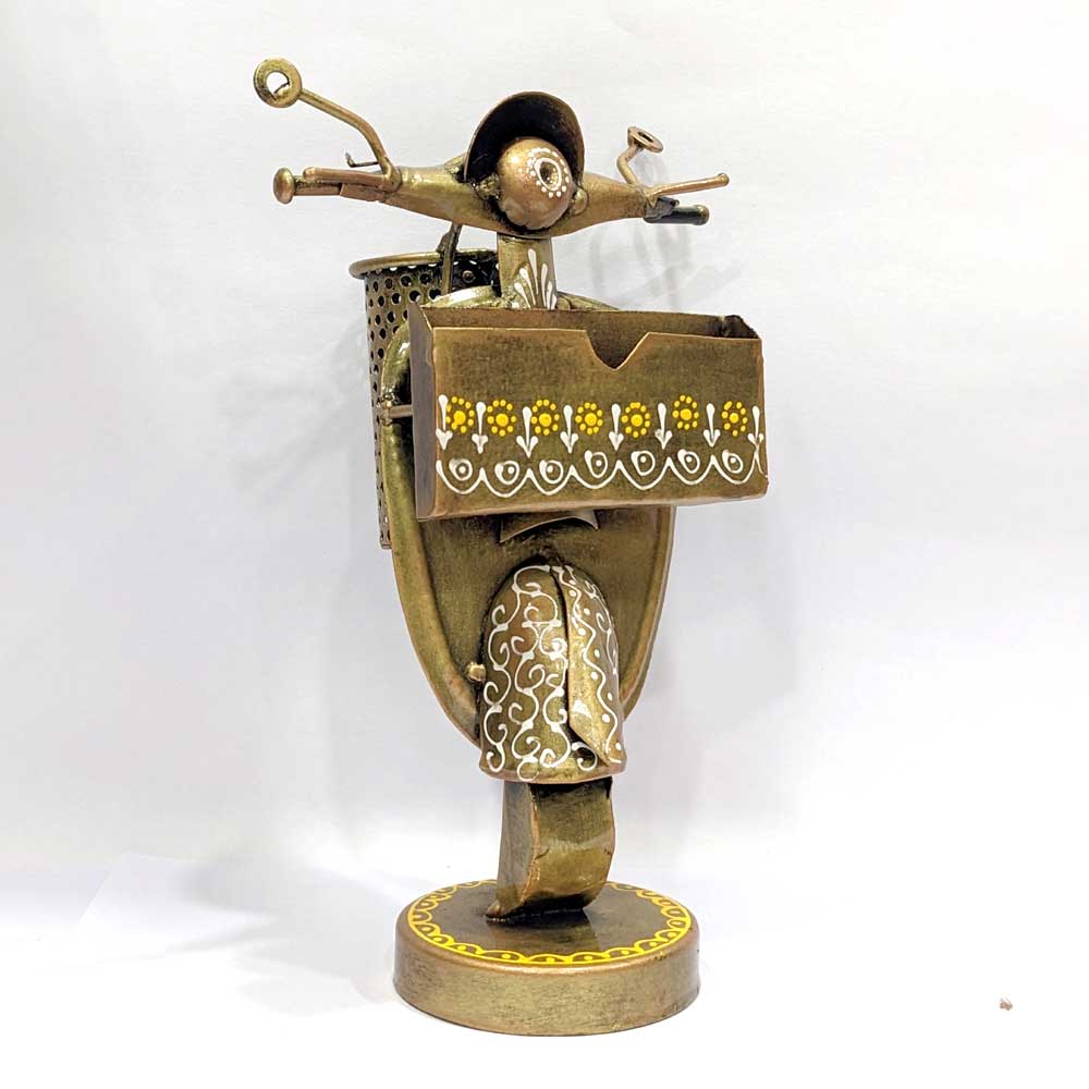 A hand-painted metallic card holder that is a useful and decorative piece.