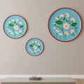 A hand-painted Rajasthani decorative wall plate featuring a delicate lotus bloom motif, symbolizing grace and new beginnings, on a premium seasoned wood base.