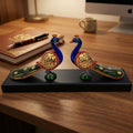 Hand-painted wooden double peacock statue with long tails on a wooden platform