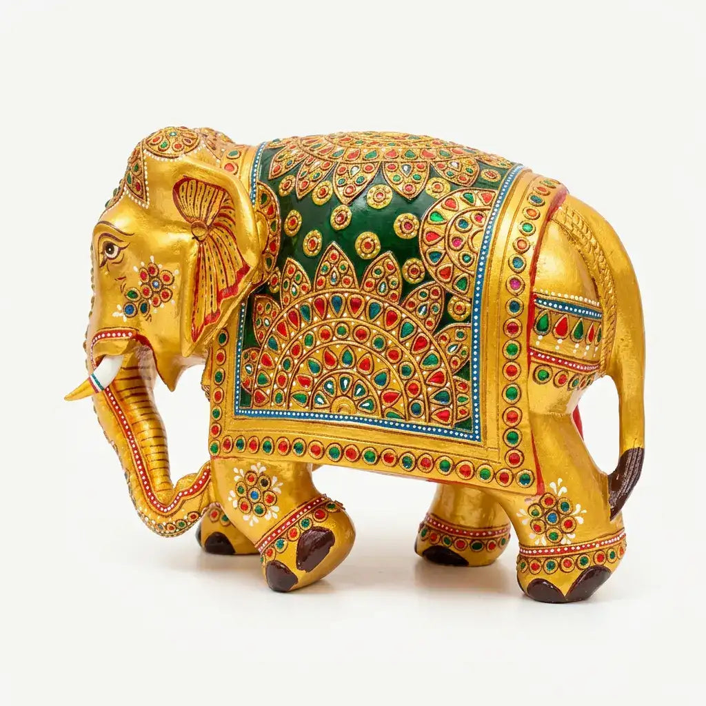 Left-facing hand-painted wooden elephant with white tusks and raised floral patterns on a deep green panel