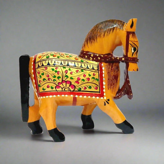 A hand-painted wooden horse showpiece decorated with golden, red, and green colors.