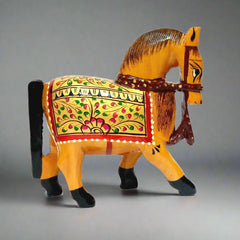 A hand-painted wooden horse showpiece decorated with golden, red, and green colors.