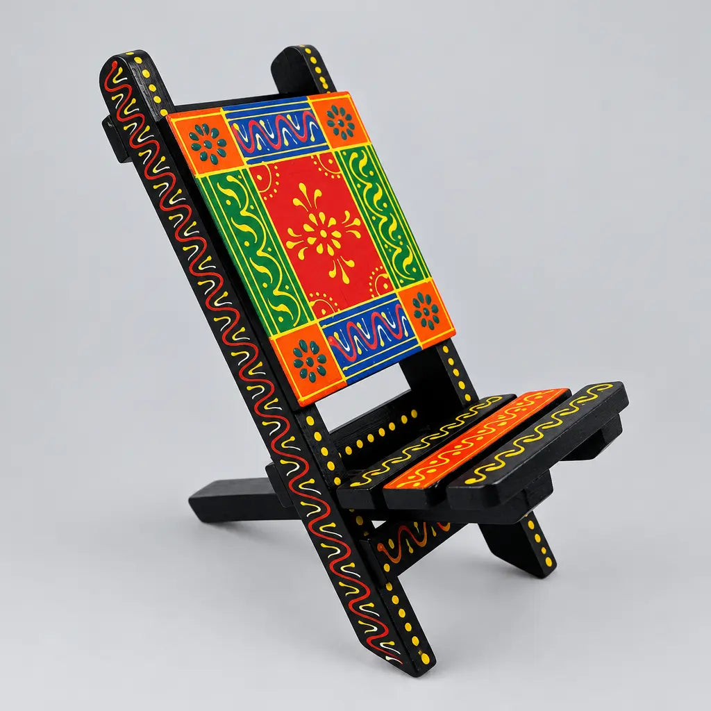 Hand painted wooden phone holder in a folding chair shape with red, green, orange and blue floral patterns.