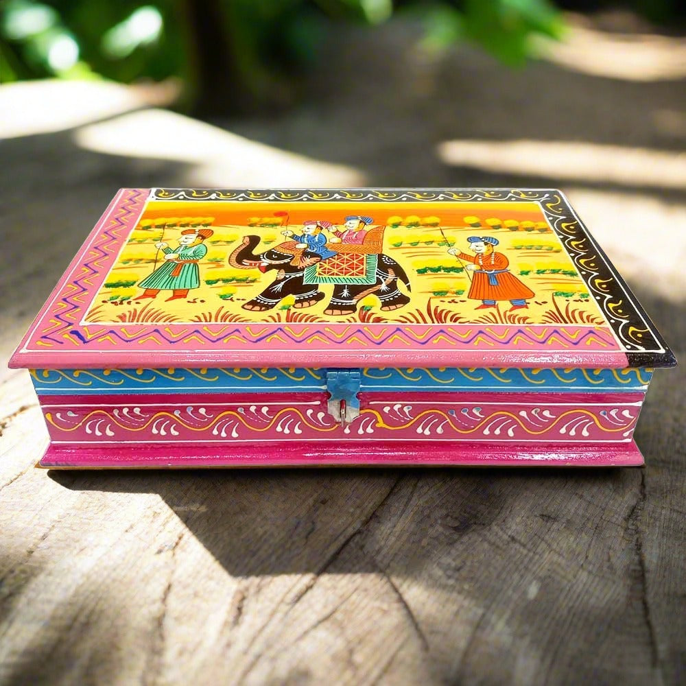 A hand-painted wooden trinket box with a traditional Indian miniature art design.