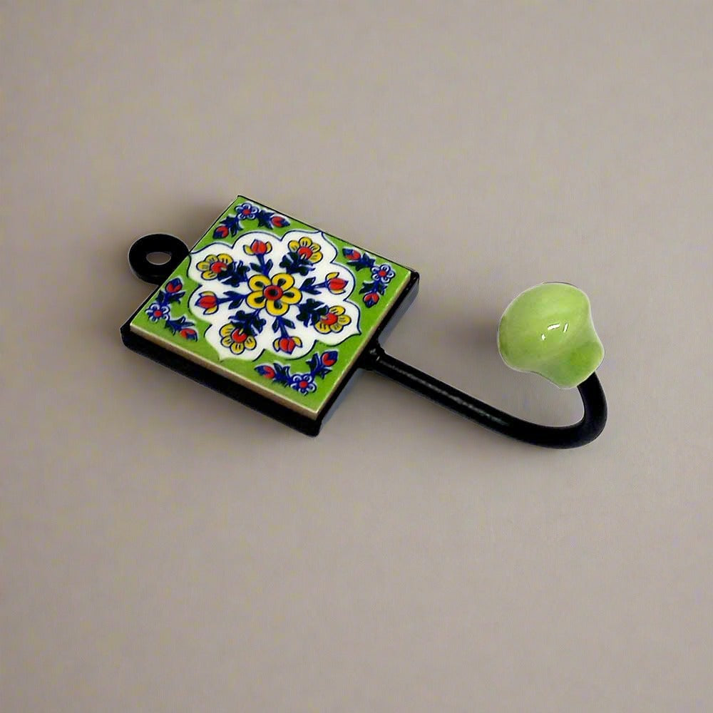 A handcrafted Blue Pottery wall art piece that functions as a hook.
