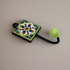 A handcrafted Blue Pottery wall art piece that functions as a hook.