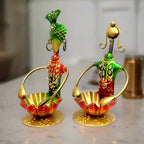 A handcrafted couple showpiece with a tea-light holder, ideal for home decoration.