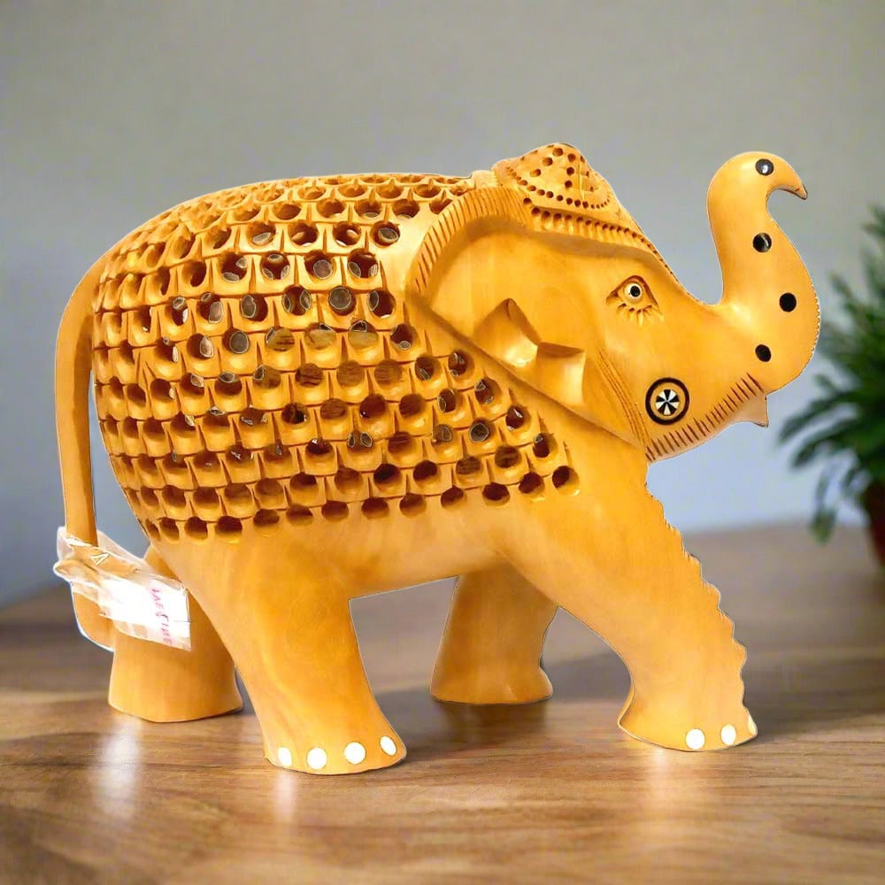 Wooden elephant statue featuring baby elephant carved inside lattice design.