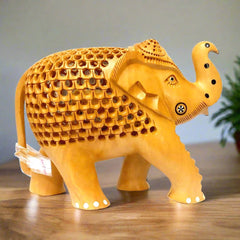 Wooden elephant statue featuring baby elephant carved inside lattice design.