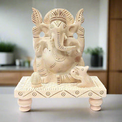 Handcrafted Ganesha statue made of Sawan wood seated on carved chowki.