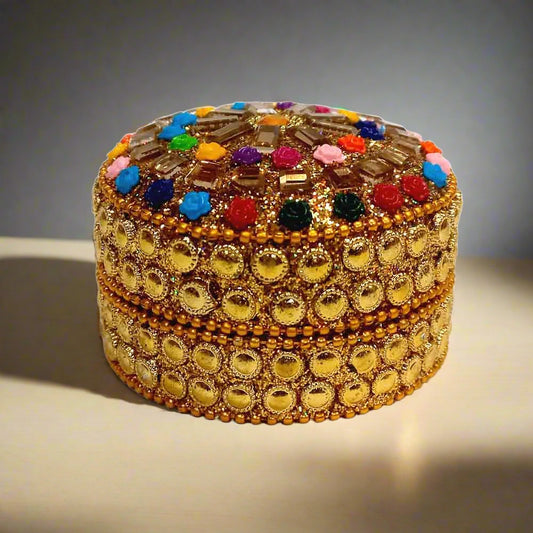 A handmade lacquered box with an intricate design, used as a jewelry organizer or trinket box.