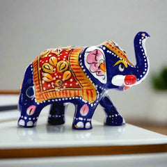 Handcrafted baby elephant idol decorated with Meenakari painting and golden accents.