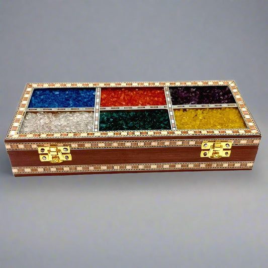 Handcrafted wooden box with gemstone inlay design for storage and decor.