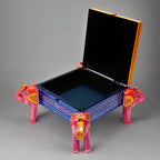 Artisan-crafted wooden jewelry box with vibrant elephant motif, embossed patterns, and soft velvet-lined compartments.